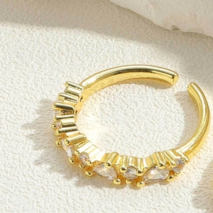 Detailed shot of adjustable gold-plated ring featuring sparkling cubic zirconia stones