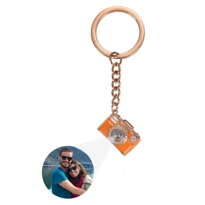 Detailed projection of custom couple photo from rose gold camera charm keychain
