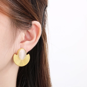 Vintage gold-tone square fan-shaped cat eye stud earrings shown from a side profile view