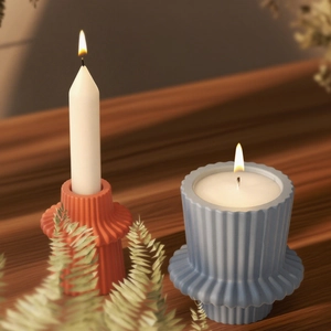 Macro detail of geometric pleated candle holders with orange and blue textured finishes