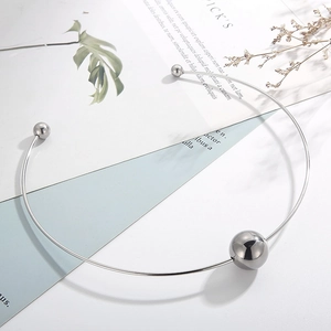 Detail view of silver hollow steel ball choker with minimalist polished metallic finish
