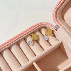 Golden fish earrings with round cubic zirconia pendants in a pink velvet jewelry box