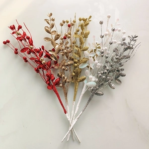 Close-up of glitter-coated decorative Christmas berry branches in red, gold, white, and silver
