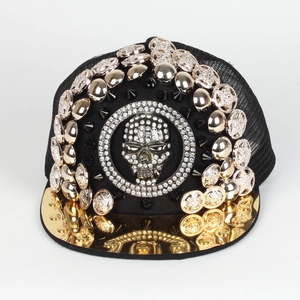 Detail of luxury baseball cap with silver rivets and gold mirror brim and skull badge