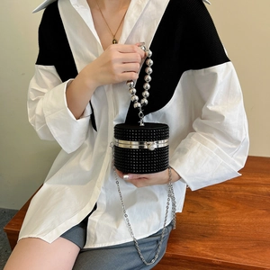 Sparkly black cylindrical evening bag with silver pearl handle and chain crossbody strap