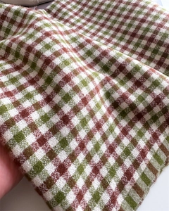 Close-up of soft cashmere-like plaid scarf texture in red, green and white check pattern