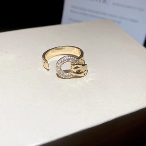 Macro shot of gold-plated panther ring with white pavé-set stones and adjustable open band