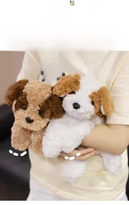 Close-up of fluffy plush puppy toys in brown and white being held to show soft texture