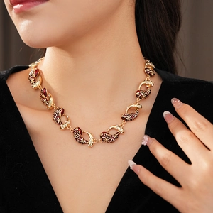 Detail of vintage red enamel teardrop necklace with crystals on model neck