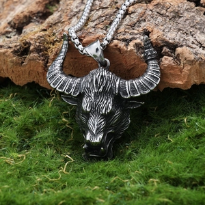Detailed view of silver ox head pendant on tree bark with stainless steel fox tail chain