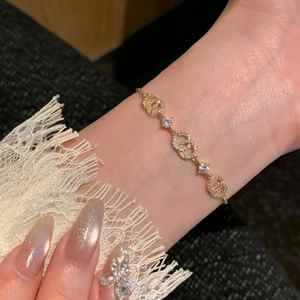 Macro shot of 18k gold plated bracelet with cubic zirconia circles on female wrist