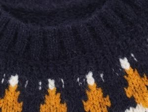 Detail of navy blue knit sweater with yellow geometric jacquard and ribbed crew neck