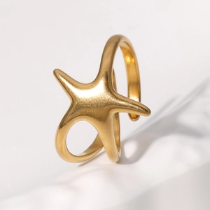 Minimalist golden starfish open ring in matte finish on a white stone pedestal