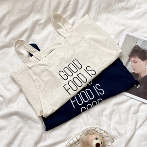 Minimalist canvas tote bag set in beige and navy blue with Good Food Is Good lettering