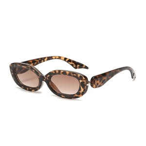 Modern oval leopard print sunglasses with dark gradient lenses and wide temples