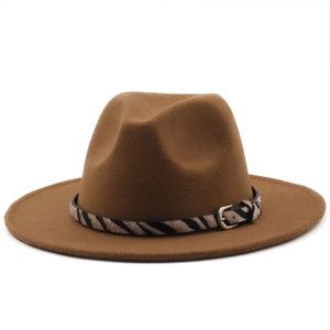 Detail of caramel fedora hat with zebra print band and silver buckle on white background