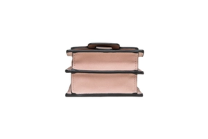 Side view of pink leather mini phone bag with black trim and multi-layered structure