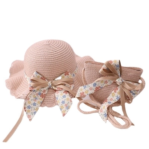Pink girls straw sun hat and matching crossbody bag set with floral bow decoration