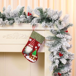 Detail of hanging large burlap Christmas stocking with gnome and Noel embroidery