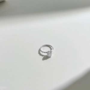 Macro shot of an elegant S925 sterling silver ring with oval cut gemstone on white backdrop