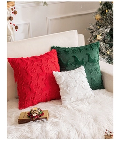 Close-up of plush Christmas pillow covers with festive embroidery and fringe details
