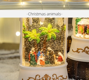 Close-up of Christmas nativity scene snow globe with golden embossed base and glowing light