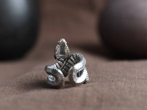 Macro view of vintage 925 sterling silver snake ring with golden eye detail and S925 mark