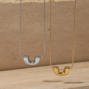 Minimalist U-shaped pendant necklace in gold and silver finish with sleek snake chain