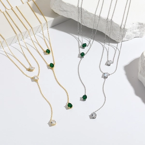 Double-layer Y-shaped necklaces with green and white teardrop emerald pendants in gold and silver