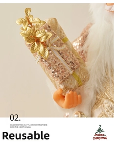 Detail of rose gold Santa doll holding a sequined gift box with white faux fur trim