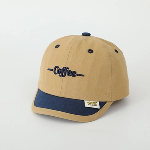 Detail of embroidered coffee text and logo label on two-tone kids baseball cap