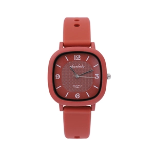 Detail of red square quartz watch with textured dial and soft silicone strap