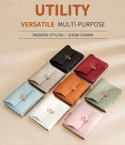 Flat lay of small stylish buckle wallets in eight various colors with floral metal clasp