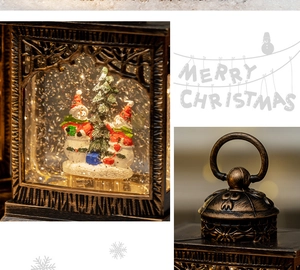 Detailed view of bronze Christmas lantern with LED snow globe scene and hanging ring