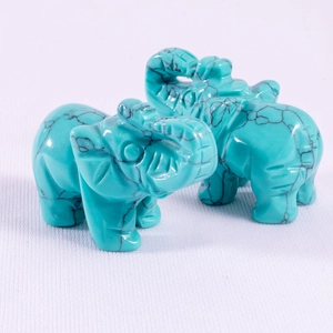 Macro detail of turquoise elephant figurines showing natural black mesh textures and carving