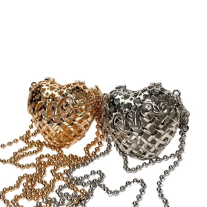 Elegant gold and silver heart-shaped hollow metal clutch bags with sleek chain straps