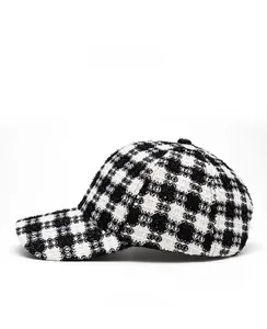 Side view of black and white plaid tweed baseball cap showing detailed fabric texture