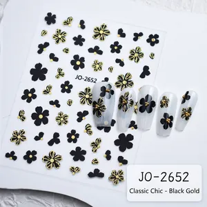 Detail view of 3D embossed black and gold floral nail art stickers and application effect
