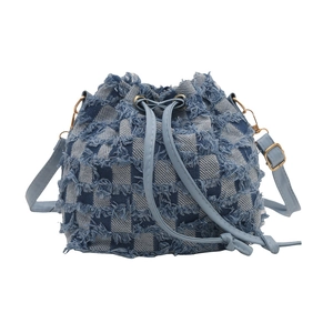 Blue denim pleated bucket bag with tassel edges and leather drawstring shoulder strap