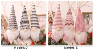 Dettaglio di gnomi in grigio e rosa con cappelli di maglia e barbe di peluche appesi al ramo