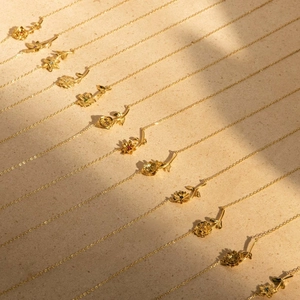 Multiple 18K gold plated flower pendant necklaces featuring diverse floral designs