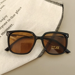 Detail of square kids sunglasses with UV400 lenses and metal rivets on frame