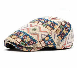 Detailed view of beige newsboy cap featuring colorful ethnic geometric jacquard fabric