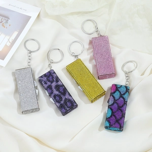 Diamond-encrusted aluminum alloy pill organizers in five vibrant colors with keychains