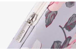 Close-up of durable silver metal zipper on white rose floral laptop sleeve fabric