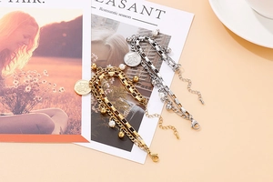 Detailed shot of double-layered stainless steel Hamsa hand bracelet with pearl charm