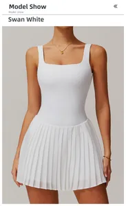 Detailed view of the square neck bodice and fine pleated hem on white tennis dress