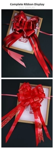 Detail of red wedding car pull bows with gold Marry Me lettering and rose patterns