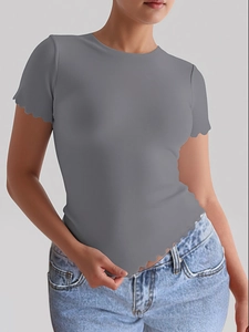 Detail of grey yoga T-shirt with curved wave hemline and slim fit athletic material