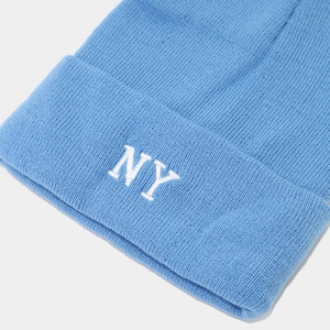 Close-up of light blue knit beanie featuring detailed white NY letter embroidery
